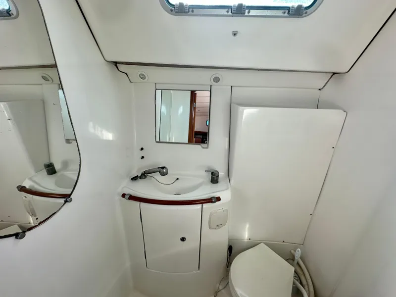Slide: The Image of Bathroom interior of 2002 Beneteau Oceanis Clipper 393 yacht, featuring sink and mirror. - 36
