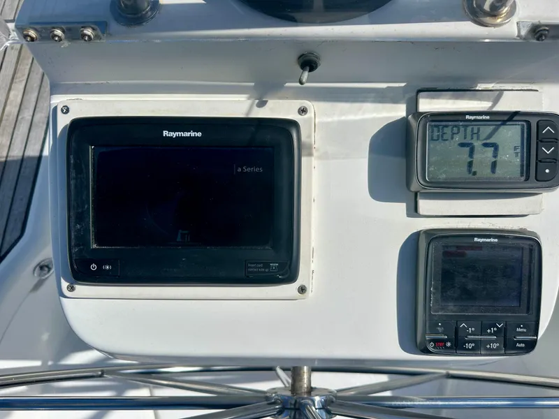 Slide: The Image of Beneteau Oceanis Clipper 393 cockpit instruments, featuring Raymarine displays and depth gauge. - 37