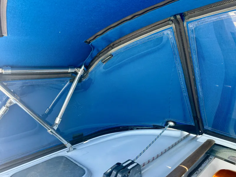 Slide: The Image of Beneteau Oceanis Clipper 393, 2002 model, featuring blue cockpit canopy and support struts. - 48