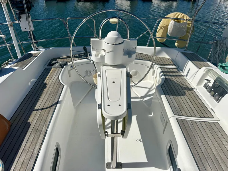 Slide: The Image of 2002 Beneteau Oceanis Clipper 393 yacht cockpit with steering wheel and teak decking. - 49
