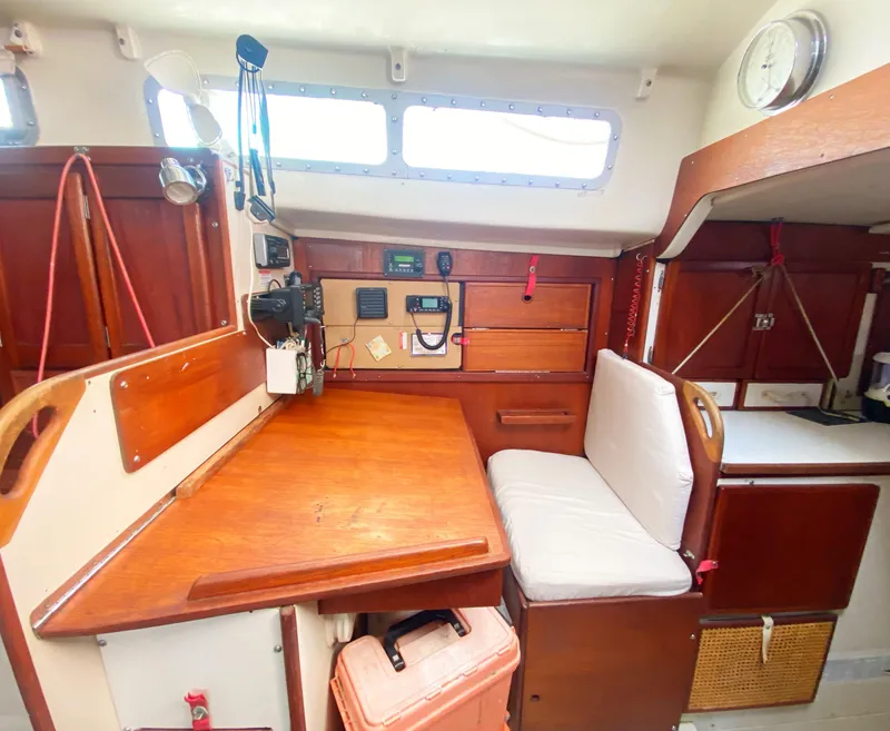Slide: The Image of 1975 Whitby 42 Center Cockpit interior with navigation station and seating area. - 19