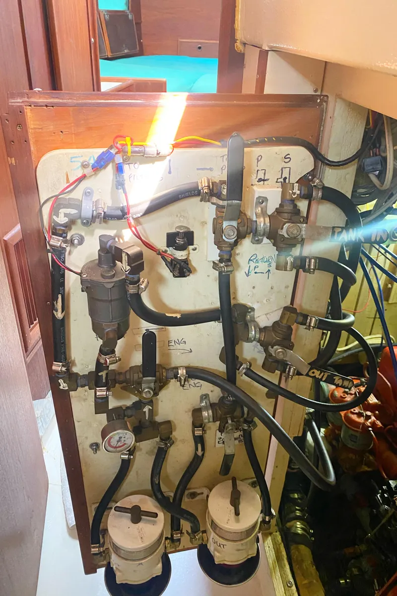 Slide: The Image of Engine compartment of a 1975 Whitby 42 Center Cockpit sailboat, showcasing fuel system components. - 42
