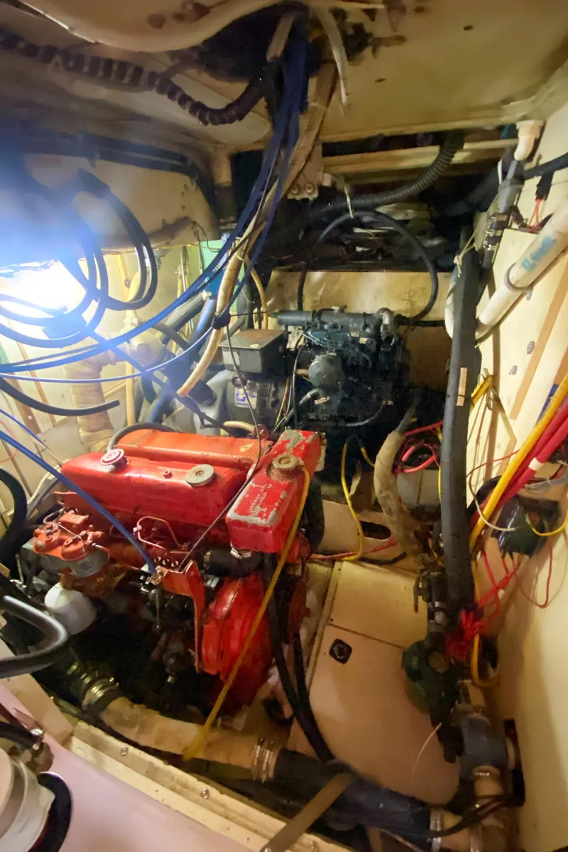 Slide: The Image of Engine room of a 1975 Whitby 42 Center Cockpit sailboat with visible wiring and components. - 44
