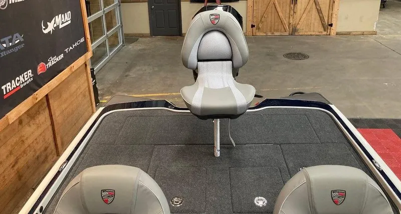 Slide: The Image of 2025 Triton 20XP boat interior with gray seating in a garage setting. - 10