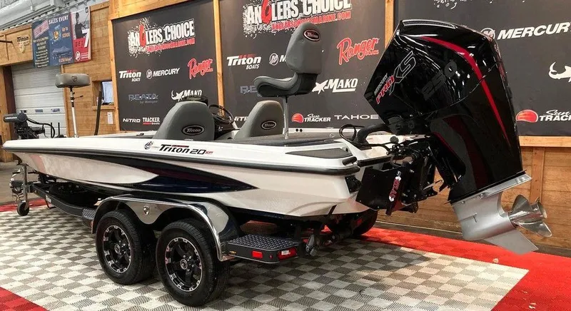 Slide: The Image of 2025 Triton 20XP boat on display with powerful outboard motor. - 3
