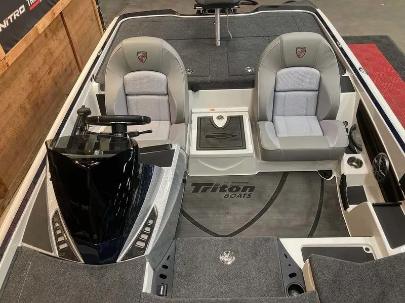 Slide: The Image of 2025 Triton 20XP boat interior with dual seats and steering console. - 9