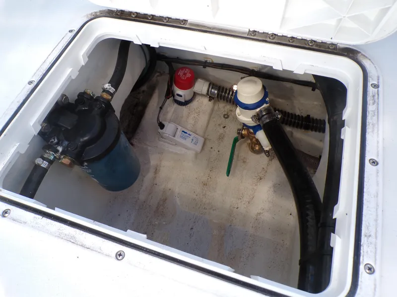 Slide: The Image of 2024 Parker 1801 Center Console boat compartment with hoses and equipment. - 13