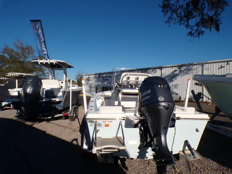 Slide: The Image of 2024 Parker 1801 Center Console boat with Yamaha outboard motor, displayed outdoors. - 2