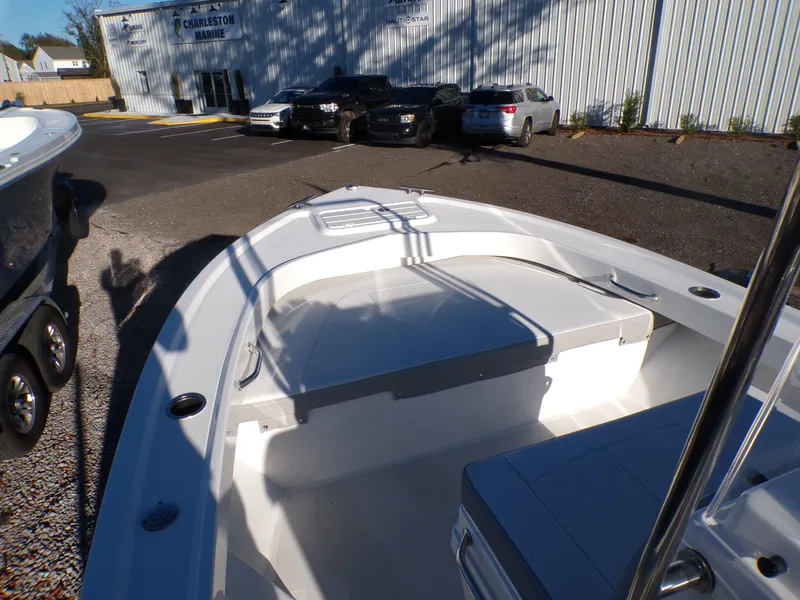 Slide: The Image of 2024 Parker 1801 Center Console boat in a parking lot near a warehouse. - 26