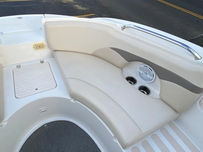 Slide: The Image of 2005 Chaparral Sunesta 254 boat interior with cushioned seating and cup holders. - 12