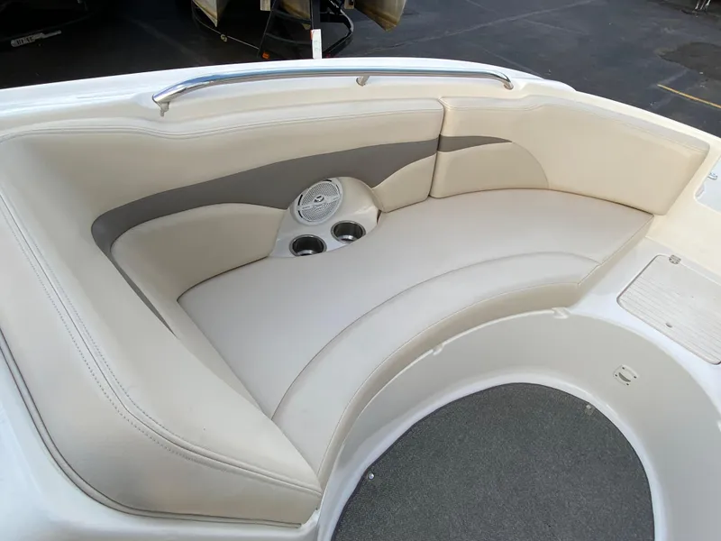 Slide: The Image of 2005 Chaparral Sunesta 254 boat interior with cushioned seating and cup holders. - 17