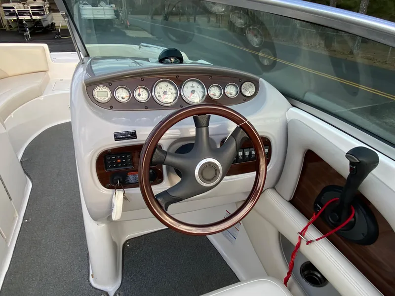 Slide: The Image of 2005 Chaparral Sunesta 254 boat dashboard with steering wheel and instrument panel. - 20