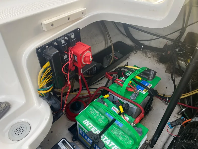 Slide: The Image of 2005 Chaparral Sunesta 254 boat battery compartment with wiring and Interstate batteries. - 25