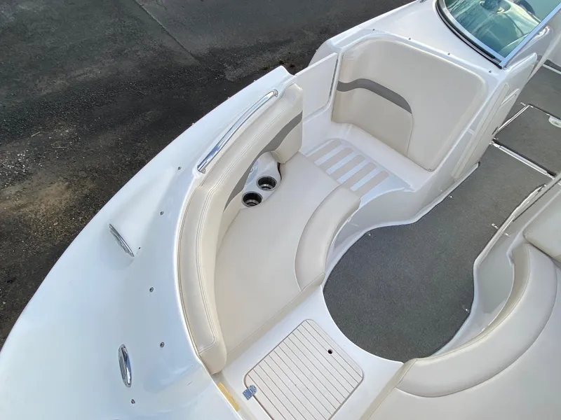 Slide: The Image of 2005 Chaparral Sunesta 254 boat interior with white seating and cup holders. - 26