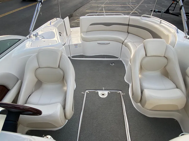 Slide: The Image of 2005 Chaparral Sunesta 254 boat interior with white seating and gray carpet. - 27