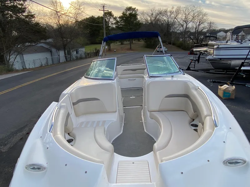 Slide: The Image of 2005 Chaparral Sunesta 254 boat with open bow seating, parked on a road. - 28