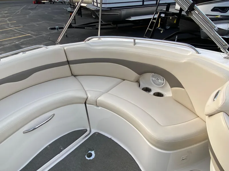 Slide: The Image of 2005 Chaparral Sunesta 254 boat interior with beige seating and cup holders. - 29