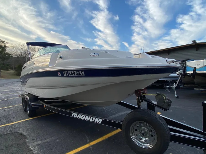 Slide: The Image of 2005 Chaparral Sunesta 254 boat on a Magnum trailer under a partly cloudy sky. - 3