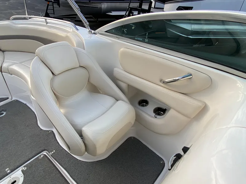 Slide: The Image of 2005 Chaparral Sunesta 254 boat interior with white seating and cup holders. - 30