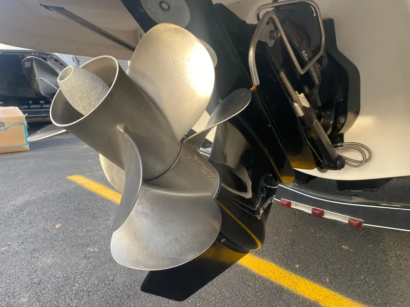 Slide: The Image of Close-up of a 2005 Chaparral Sunesta 254 boat propeller in a parking lot. - 32