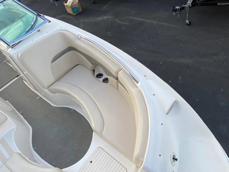 Slide: The Image of 2005 Chaparral Sunesta 254 boat interior with beige seating and cup holders. - 9