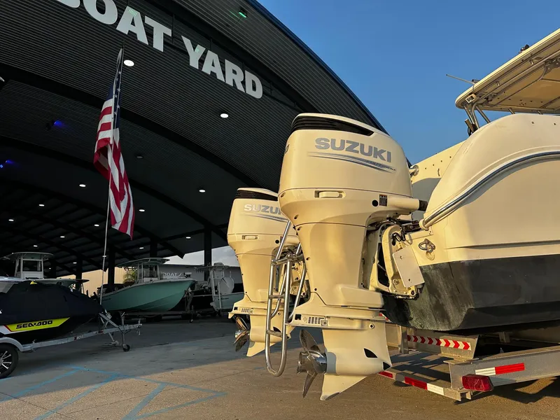 Slide: The Image of 2005 World Cat 320EC with Suzuki engines at a boat yard. - 12