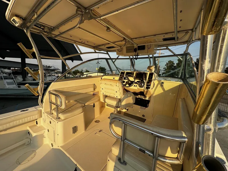 Slide: The Image of Interior of a 2005 World Cat 320EC boat, featuring helm and seating area. - 15