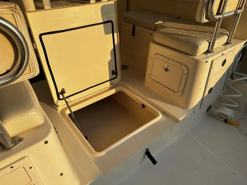 Slide: The Image of Open storage compartment on a 2005 World Cat 320EC boat deck. - 18