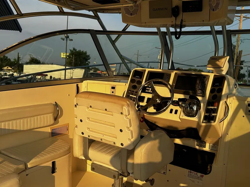Slide: The Image of 2005 World Cat 320EC boat cockpit with steering wheel and navigation equipment. - 5