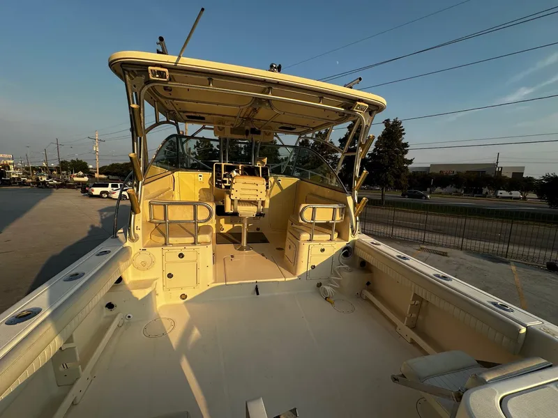 Slide: The Image of 2005 World Cat 320EC boat interior, featuring spacious deck and seating area. - 6