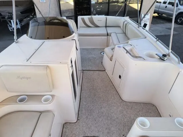 Slide: The Image of 1998 Ebbtide 2300 Mystique Deck Boat interior with spacious seating and cup holders. - 13