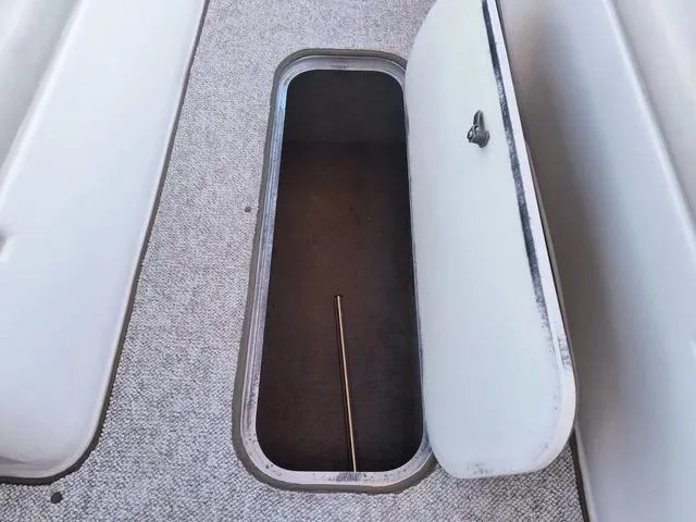 Slide: The Image of Storage compartment on 1998 Ebbtide 2300 Mystique Deck Boat, open with visible interior. - 14