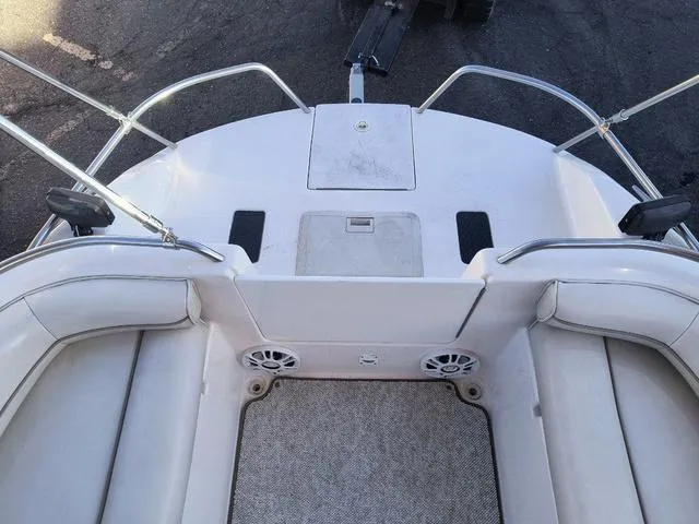 Slide: The Image of 1998 Ebbtide 2300 Mystique Deck Boat interior with seating and speakers. - 16