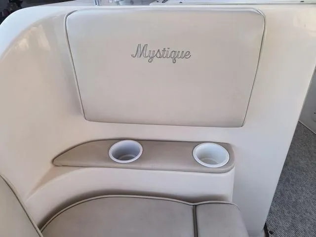 Slide: The Image of 1998 Ebbtide 2300 Mystique Deck Boat interior with cup holders and embroidered seat. - 17