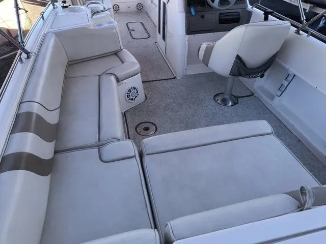 Slide: The Image of 1998 Ebbtide 2300 Mystique Deck Boat interior with spacious seating and steering console. - 18