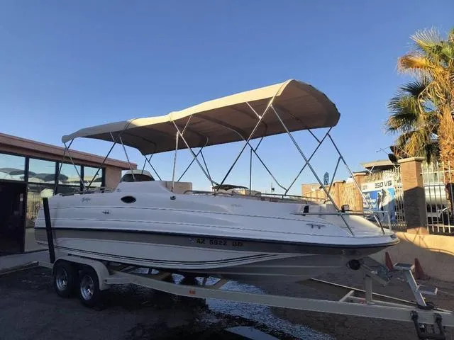 Slide: The Image of 1998 Ebbtide 2300 Mystique Deck Boat on trailer with canopy, parked outdoors. - 4