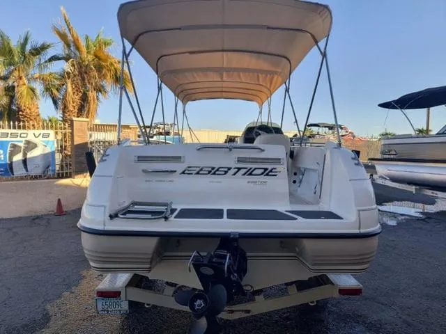 Slide: The Image of 1998 Ebbtide 2300 Mystique Deck Boat with canopy, parked outdoors. - 6