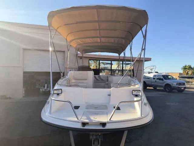 Slide: The Image of 1998 Ebbtide 2300 Mystique Deck Boat with canopy, parked outdoors. - 7