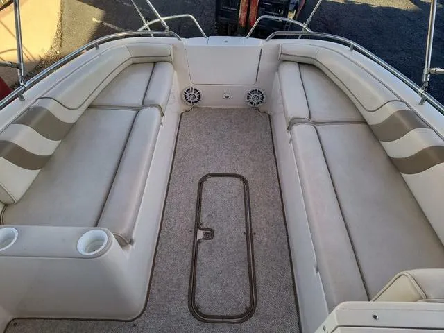 Slide: The Image of 1998 Ebbtide 2300 Mystique Deck Boat interior with spacious seating and cup holders. - 9