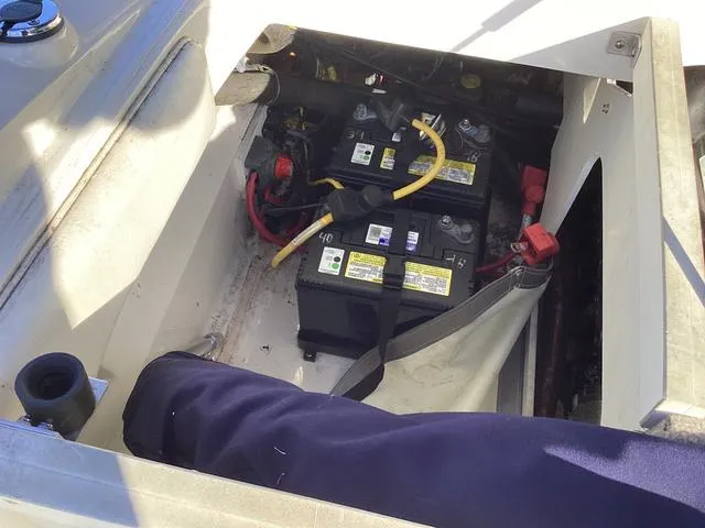 Slide: The Image of 2012 Monterey Sport Boat 184FS battery compartment with dual batteries and wiring. - 11