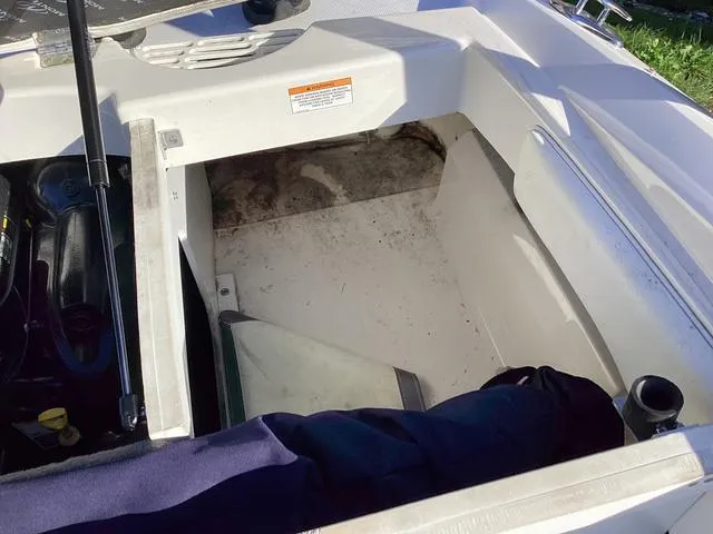 Slide: The Image of 2012 Monterey Sport Boat 184FS interior storage compartment, open and empty. - 13