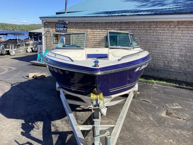 Slide: The Image of 2012 Monterey Sport Boat 184FS on trailer near a wooden building. - 2