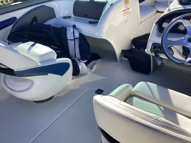 Slide: The Image of Interior of a 2012 Monterey Sport Boat 184FS with white seating and steering wheel. - 6