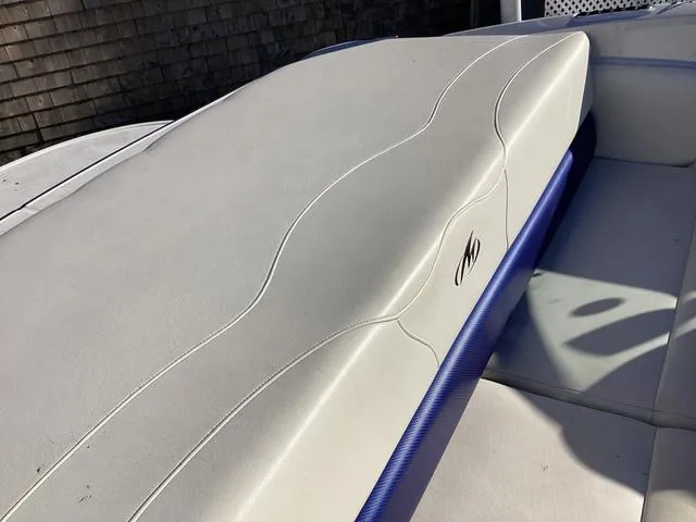 Slide: The Image of 2012 Monterey Sport Boat 184FS interior seating with white upholstery and blue accents. - 8