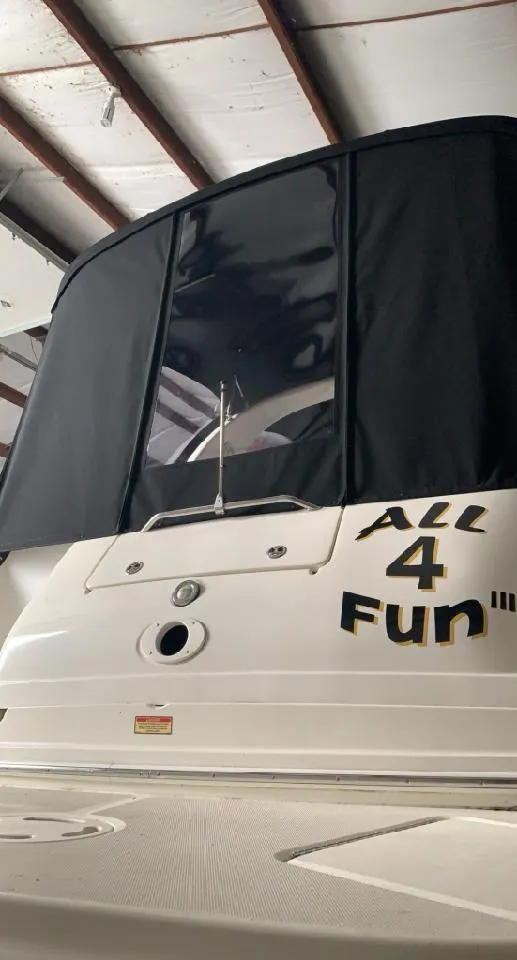 Slide: The Image of 2002 Sea Ray 300 Sundancer boat with "All 4 Fun" text on the stern, docked indoors. - 10