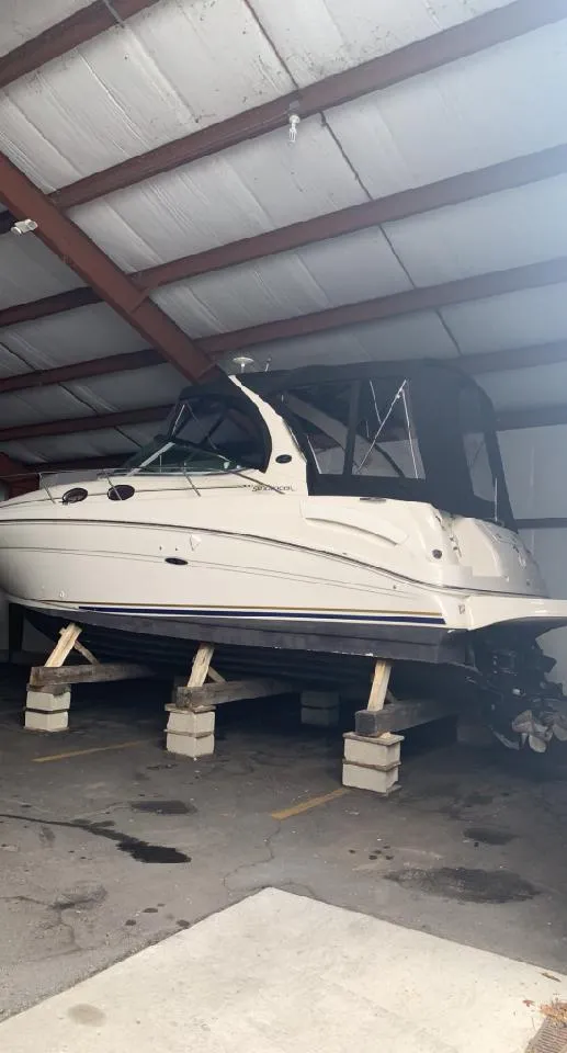 Slide: The Image of 2002 Sea Ray 300 Sundancer boat stored indoors on blocks. - 11