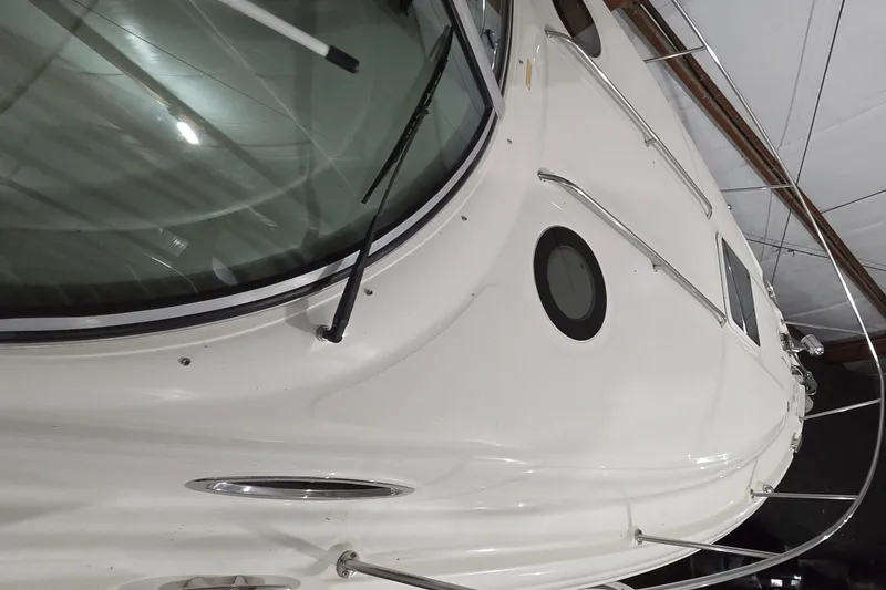 Slide: The Image of 2002 Sea Ray 300 Sundancer boat, white exterior, docked indoors. - 12