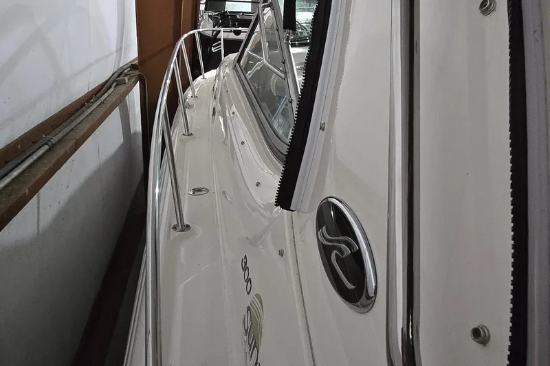 Slide: The Image of 2002 Sea Ray 300 Sundancer boat side view in storage. - 13