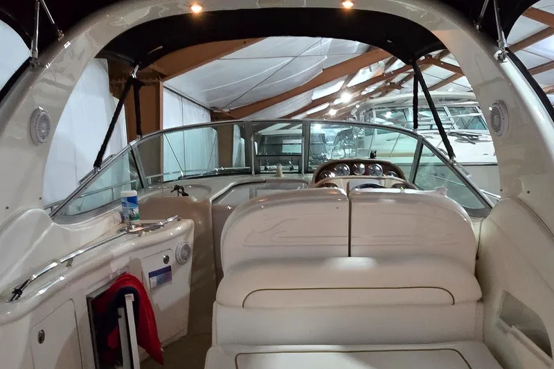 Slide: The Image of Interior view of 2002 Sea Ray 300 Sundancer boat, featuring seating and dashboard. - 15