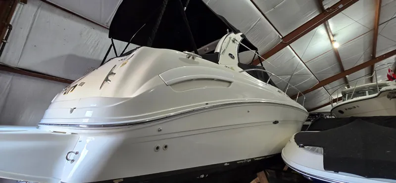 Slide: The Image of 2002 Sea Ray 300 Sundancer boat in indoor storage facility. - 2